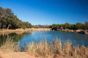 A beautiful fishing pond in a nature park located in  Abilene State Park Texas