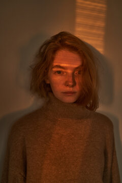 Young Woman In Sweater Standing In Shade