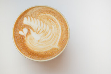 a cup of late coffee with flower shape design on top at cafe 