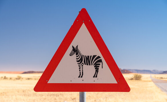 Zebra crossing danger sign in a gravel road, Namibia, Africa