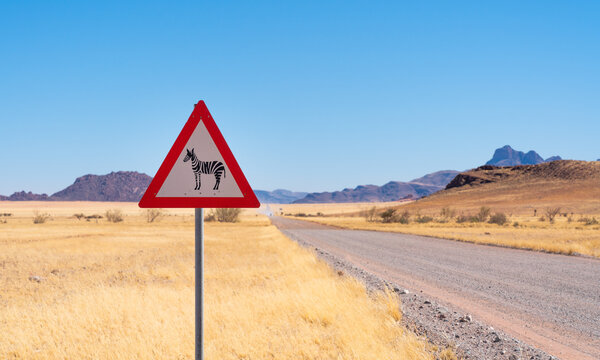 Naklejki Zebra crossing danger sign in a gravel road, Namibia, Africa