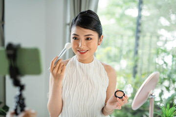 Influencer girl live streaming cosmetics product review.