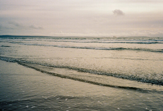 Ocean lapping at the shore in late afternoon.