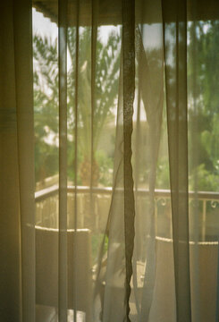 Partially obscured view through net curtains.