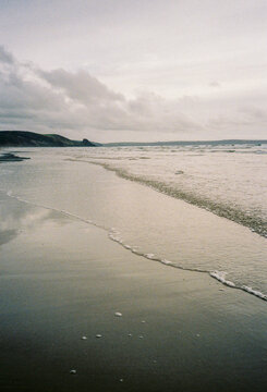 Ocean lapping at the shore in late afternoon.