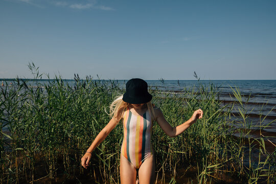 Teen girl by thickets of reed