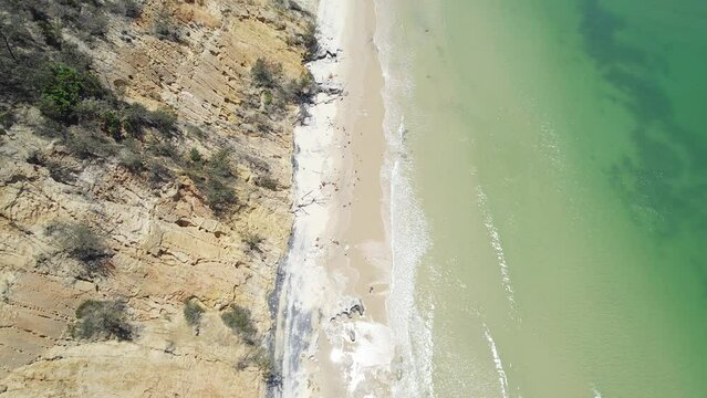 Waves Splashing On White Sandy Shore With Rocky Cliffs In Rainbow Beach, Queensland, Australia. aerial