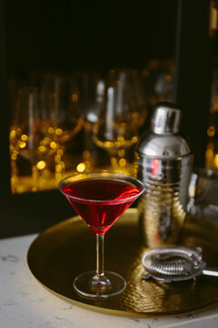 A red cosmopolitan cocktail in a martini glass
