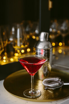 A red cosmopolitan cocktail in a martini glass