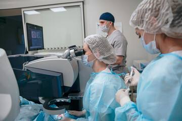 The surgeon performs an eye operation