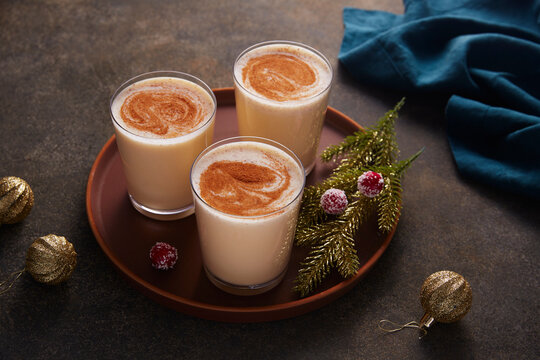 Three Glasses of Eggnog Garnished with Cinnamon and Nutmeg 