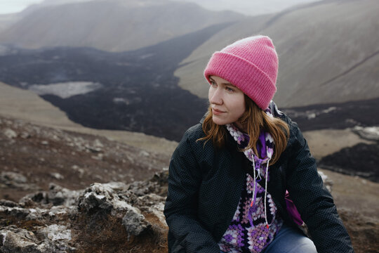 Portrait Of young Women looking on volcano in Iceland