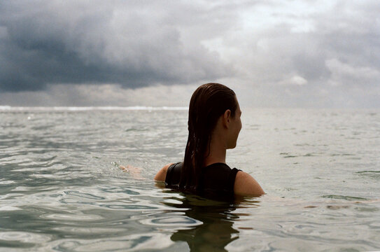 Young woman swimming in the ocean