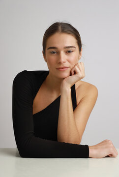 young woman leaning on table