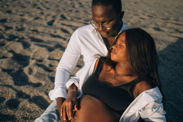 African American man embracing pregnant woman
