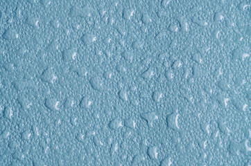 Blue abstract background, texture covered with raindrops by condensation.