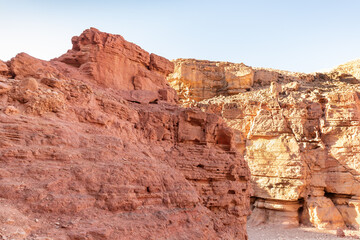 Fototapeta premium Fantastically beautiful landscape in the national nature reserve - Red Canyon in the rays of the setting sun, near the city of Eilat, in southern Israel