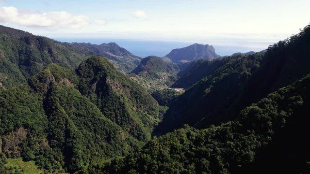 Aerial reveal of green mountain valley with vegetation ridge, Madeira