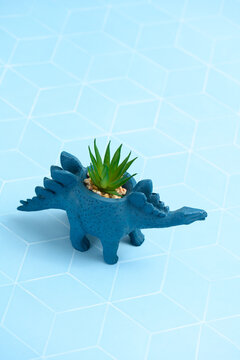 Stegosaurus dinosaur planter on blue tile
