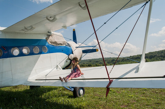 Little girl and biplane