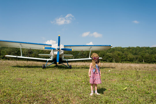 Little girl and biplane
