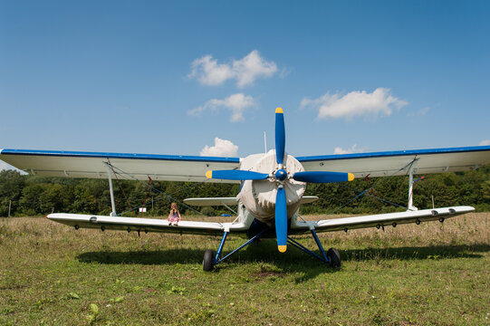 Little girl and biplane