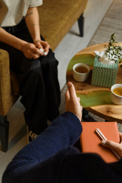 Doctor talking with female patient during psychotherapy