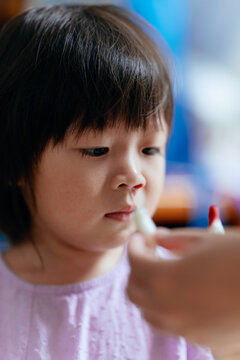 Child uses tissue to stop nosebleed