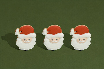  Santa Claus shaped Christmas cookie on green background