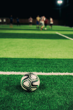 Close up of soccer ball with people in the background