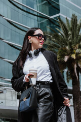 young hispanic business woman walking on the street and looking sideways in Mexico city in Latin America