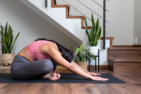 Young Woman Doing Yoga, Stretching Low Back At Home.