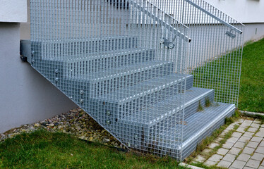 Stairs to a residential building made of stainless steel grid. galvanized stair grating made of...