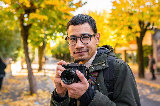 Young Man Photographer Outdoors during Autumn Season