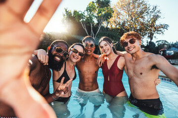 Selfie, peace sign and friends at pool party having fun partying on new year. Swimming celebration,...