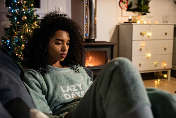 Woman reading book on Christmas day