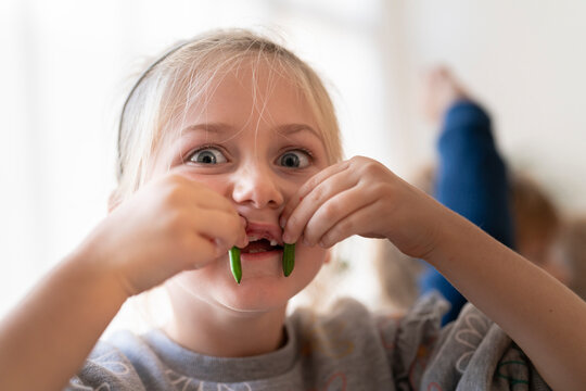little blonde girl making a face