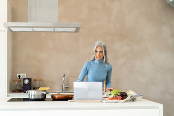 Mature woman cooking in kitchen