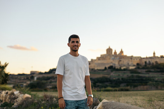 Young man looking at the views from outside the walls of Mdina