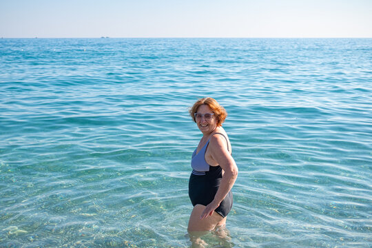 happy senior woman swimming in the sea