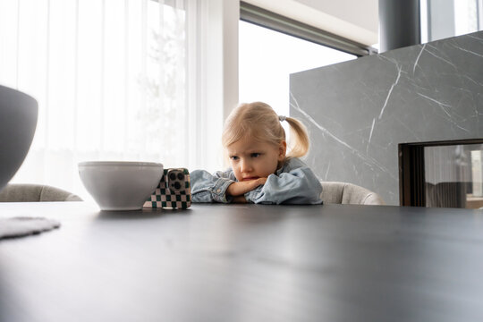 Child Watching Smartphone At The Table