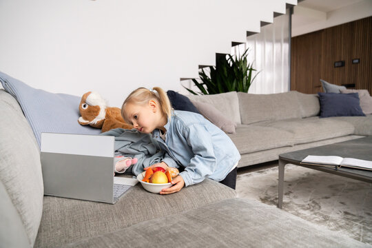 Small Girl Using Laptop At Home