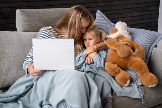 Mother Calming Daughter While Looking To Computer