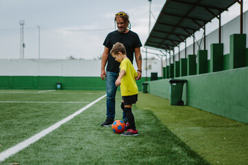 Boy gets coached at football