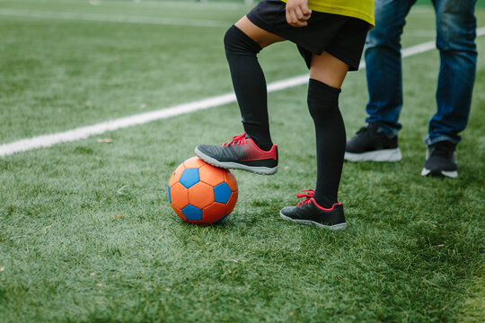 Football and childs legs