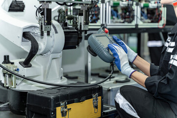 Team woman of engineers practicing maintenance Taking care and practicing maintenance of old machines in the factory so that they can be used continuously.