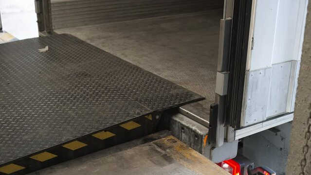 Loading ramp dock leveler adjusting height for cargo to be loaded on trailer