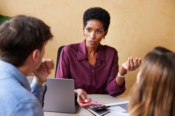 Black businesswoman discussing finances with clients