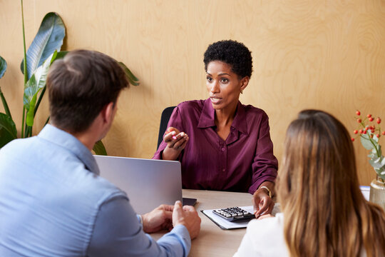 Black Financial Adviser Speaking To Couple