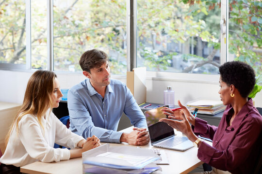 Couple listening to financial adviser